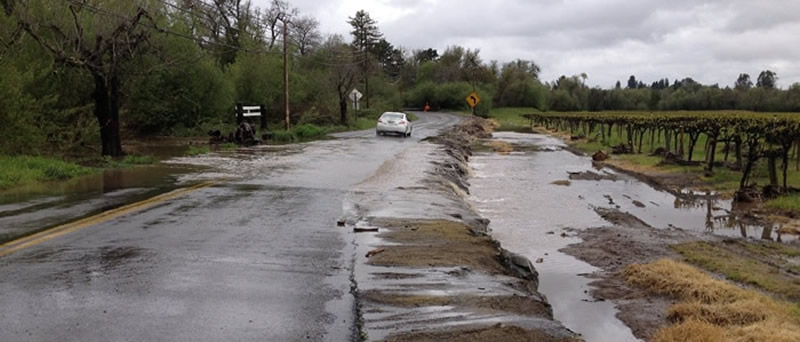 stormwater flowing over Green Valley Road